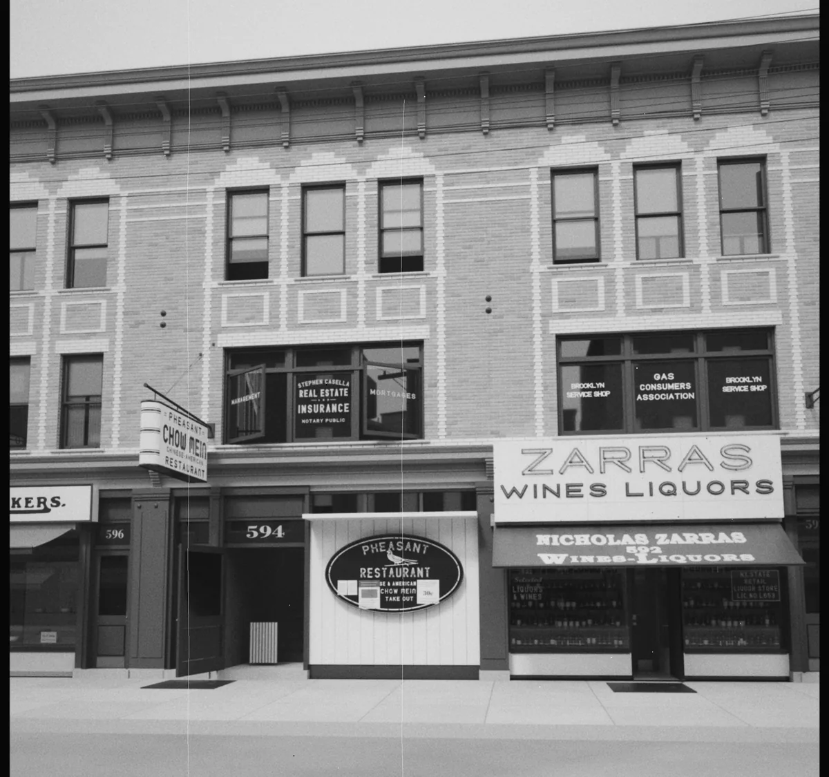 The same storefront row rendered from the 3D model through the solved 1940 camera.