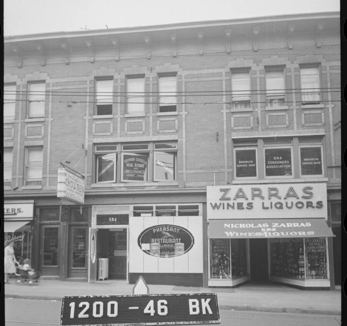 Tax photo 1200-46: the Nostrand Avenue storefront row with the ZARRAS Wines Liquors sign, the Pheasant Restaurant oval and the Chow Mein sign.