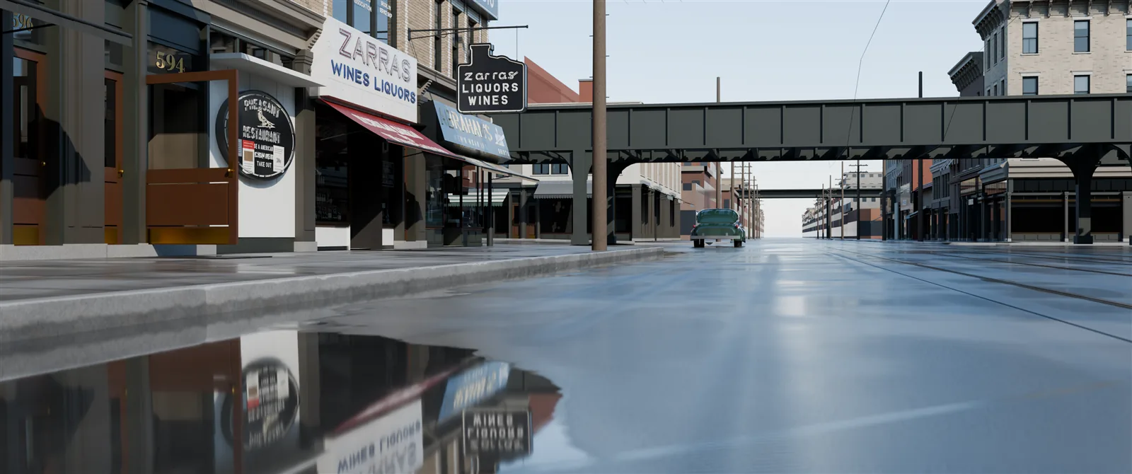 The same view by day after rain: a puddle in the foreground mirrors the Zarras signs and storefronts, and the wet street shines toward the LIRR structure.
